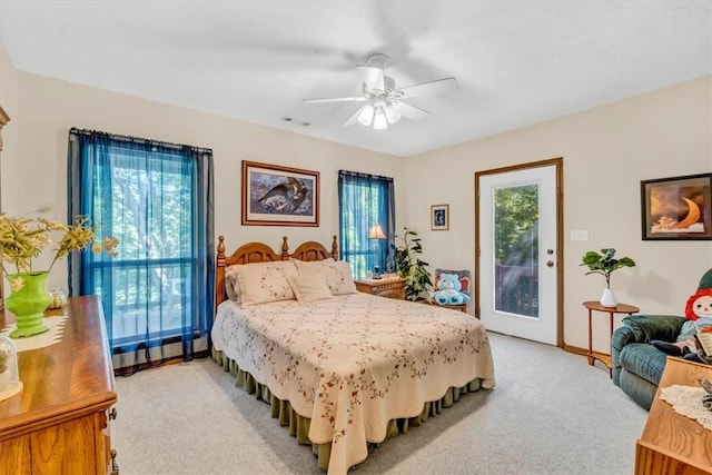 bedroom featuring access to outside, a ceiling fan, visible vents, and light colored carpet