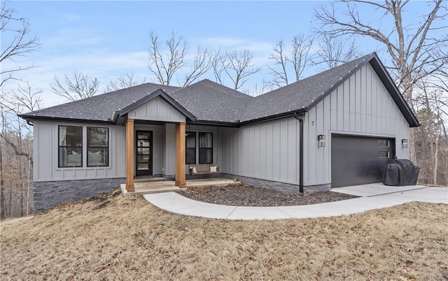 modern farmhouse style home with board and batten siding, concrete driveway, a shingled roof, and a garage