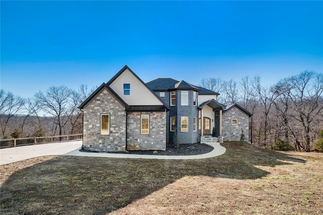 view of front of home featuring a standing seam roof, metal roof, a front yard, and fence