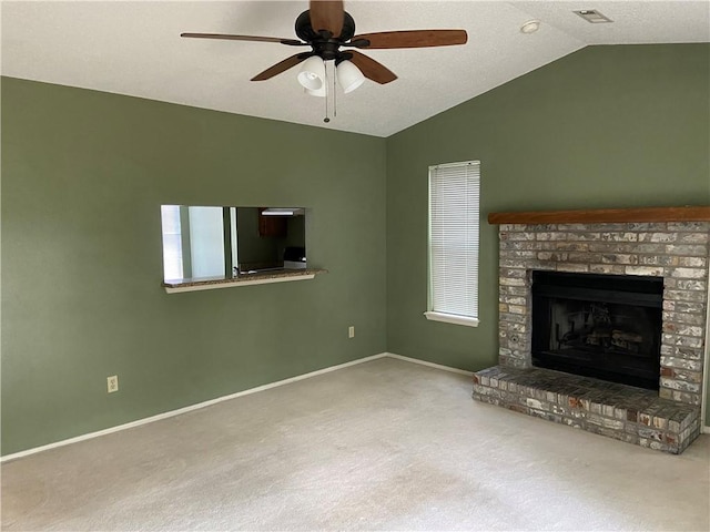 unfurnished living room with baseboards, visible vents, lofted ceiling, carpet flooring, and a fireplace