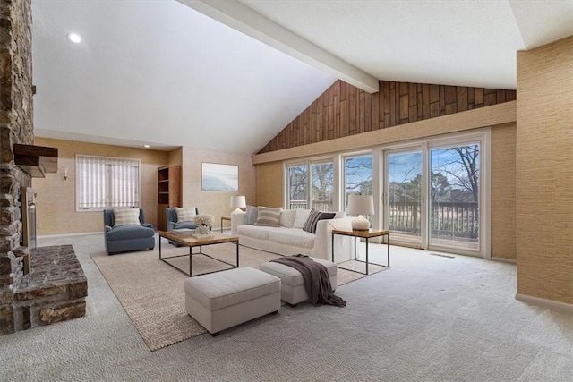 living area with visible vents, carpet, a fireplace, high vaulted ceiling, and beam ceiling