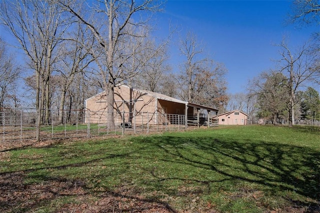 view of yard featuring fence and an outdoor structure