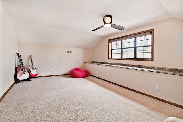 rec room featuring visible vents, baseboards, ceiling fan, carpet, and vaulted ceiling