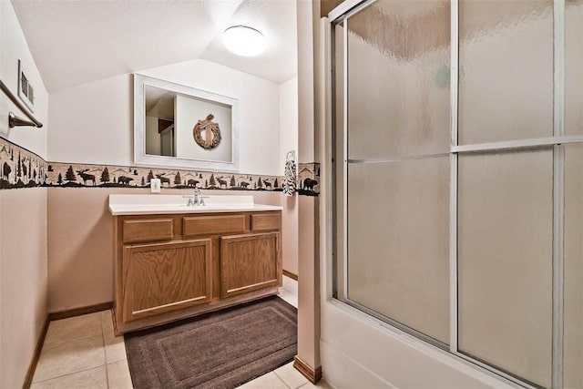 full bathroom featuring shower / bath combination with glass door, vaulted ceiling, vanity, and tile patterned floors