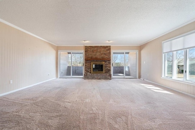 unfurnished living room with a healthy amount of sunlight, a brick fireplace, and ornamental molding