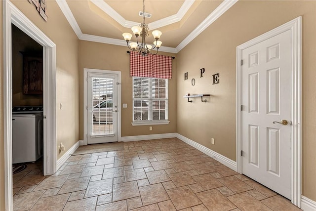 doorway with crown molding, a tray ceiling, washer / dryer, and a notable chandelier