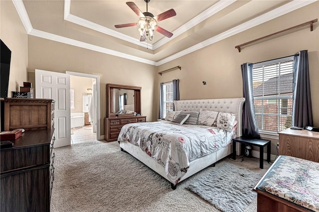 bedroom featuring carpet, ornamental molding, a raised ceiling, and ensuite bathroom