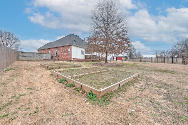 view of yard with a garden and a fenced backyard