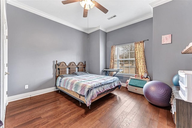 bedroom with ornamental molding, baseboards, visible vents, and hardwood / wood-style floors