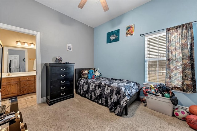 bedroom featuring lofted ceiling, light colored carpet, connected bathroom, and ceiling fan