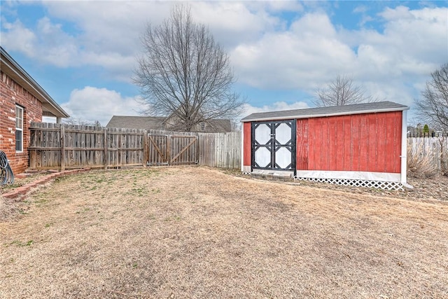 view of yard with a fenced backyard, an outdoor structure, and a shed