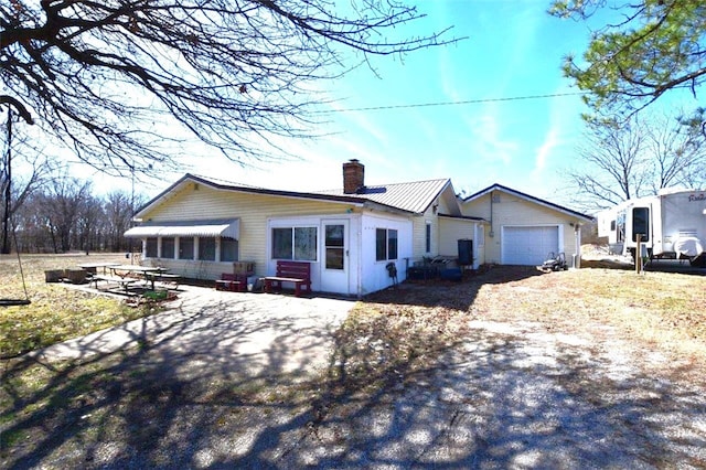 view of front of property with driveway and a chimney