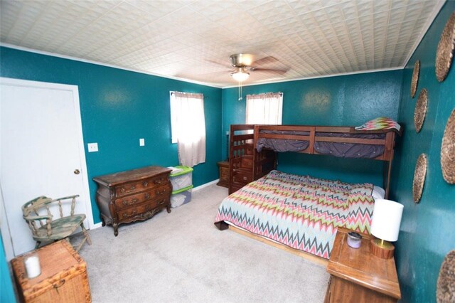 bedroom featuring a textured wall, carpet flooring, and ceiling fan