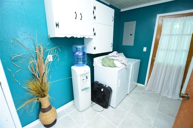 washroom with light tile patterned floors, baseboards, cabinet space, electric panel, and washer and clothes dryer