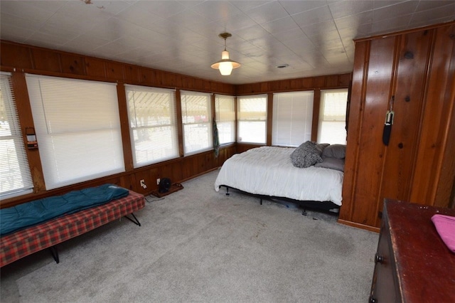 bedroom featuring carpet and wood walls