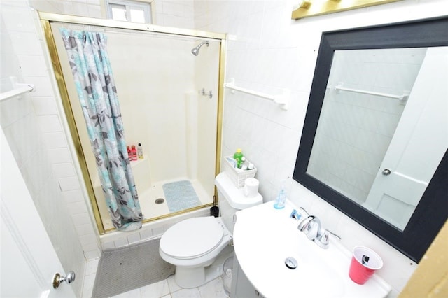 bathroom featuring tile walls, toilet, a stall shower, a sink, and tile patterned flooring