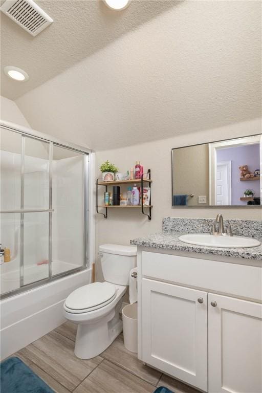 full bath featuring a textured ceiling, lofted ceiling, toilet, vanity, and visible vents