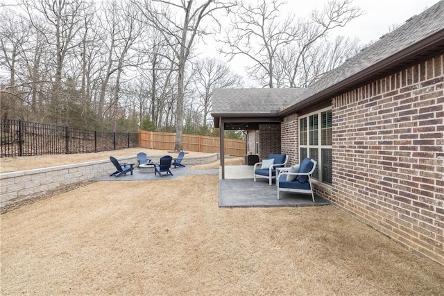 view of patio / terrace with an outdoor fire pit and a fenced backyard