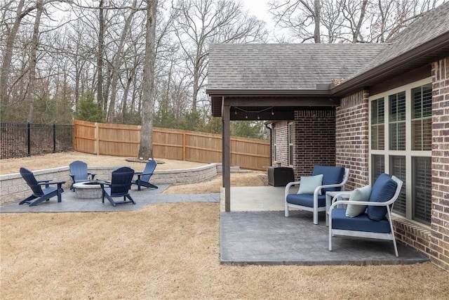 view of patio / terrace featuring fence private yard and a fire pit