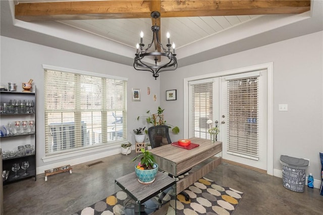 dining space featuring concrete flooring, a raised ceiling, visible vents, and a notable chandelier