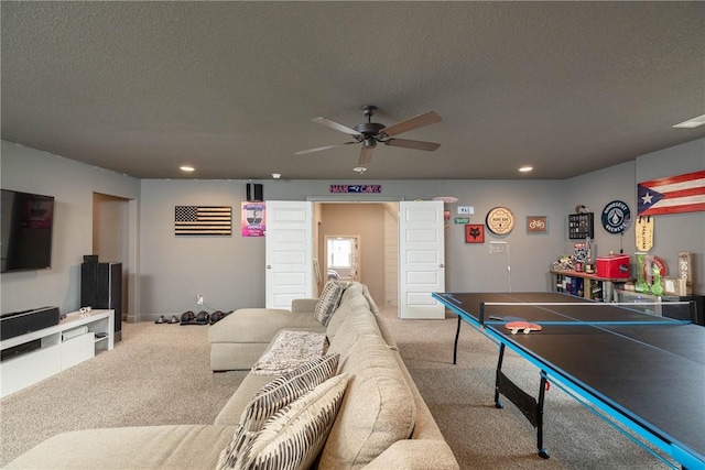 rec room featuring a textured ceiling, ceiling fan, carpet flooring, and recessed lighting