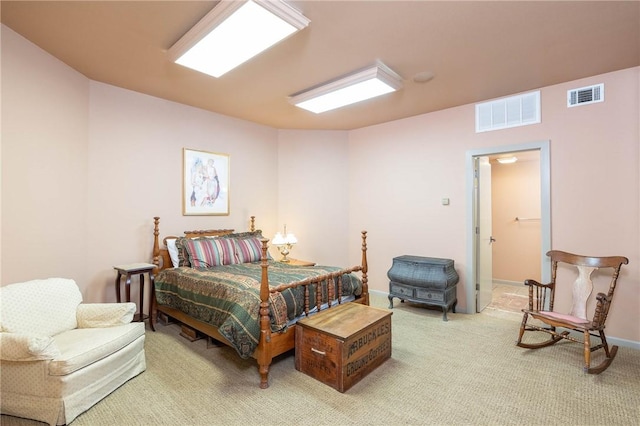 bedroom with visible vents, light carpet, and baseboards