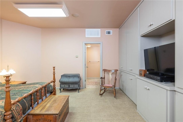 bedroom featuring visible vents and light colored carpet