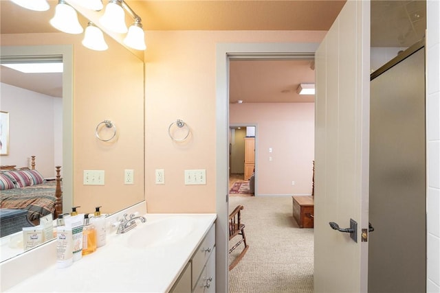 ensuite bathroom with an inviting chandelier, vanity, a shower with door, and ensuite bathroom