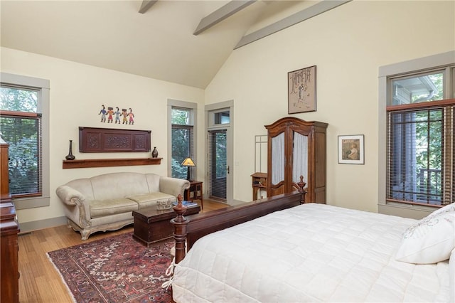 bedroom featuring access to exterior, beam ceiling, wood finished floors, high vaulted ceiling, and baseboards