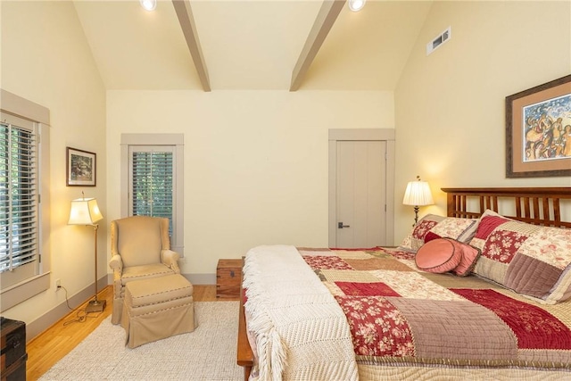 bedroom with multiple windows, beamed ceiling, and high vaulted ceiling