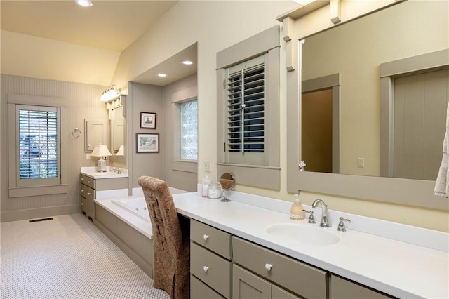 full bath featuring recessed lighting, two vanities, a sink, visible vents, and a bath