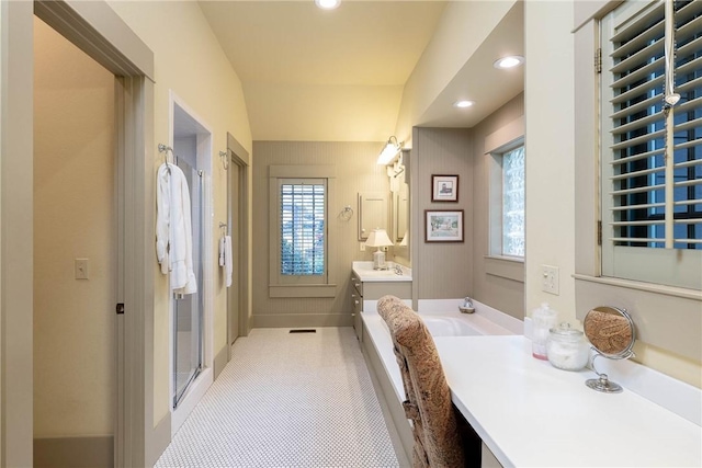 bathroom featuring a stall shower, recessed lighting, vanity, and a healthy amount of sunlight