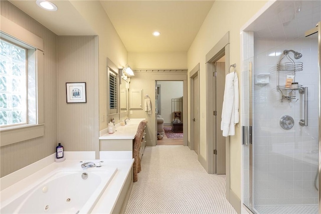 full bath featuring a stall shower, vanity, a tub with jets, and recessed lighting