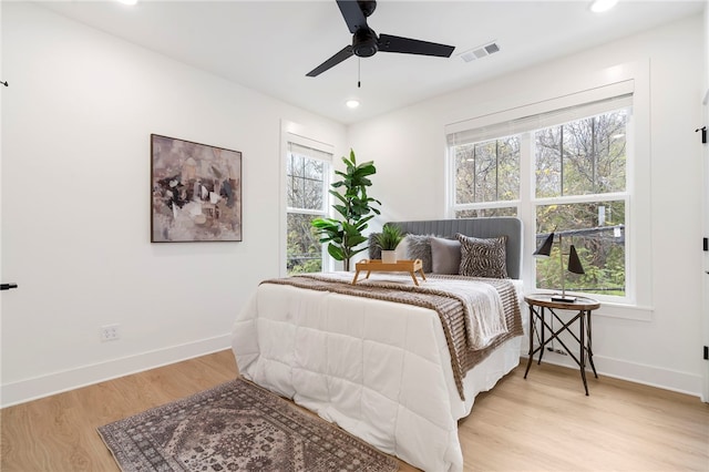 bedroom featuring baseboards, visible vents, wood finished floors, and recessed lighting