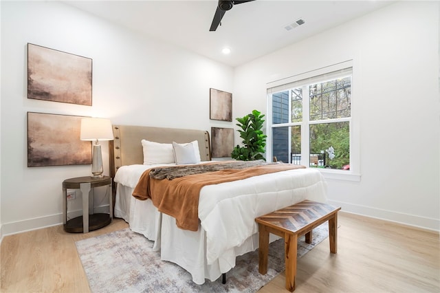 bedroom with baseboards, visible vents, wood finished floors, and recessed lighting