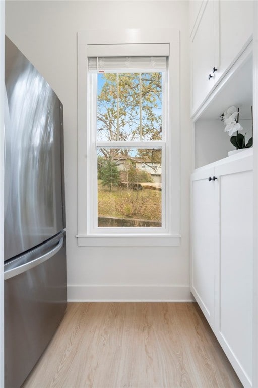 interior space featuring a healthy amount of sunlight, light wood-type flooring, and baseboards