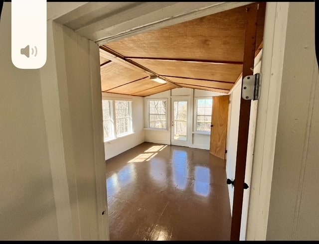 unfurnished room with vaulted ceiling with beams