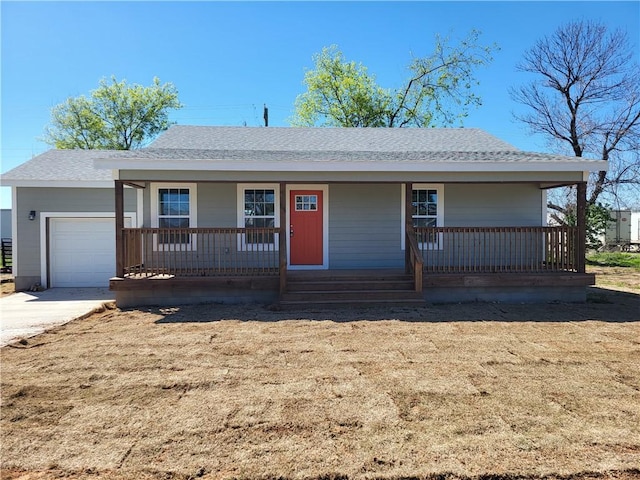 ranch-style house with a porch, concrete driveway, a shingled roof, and a garage