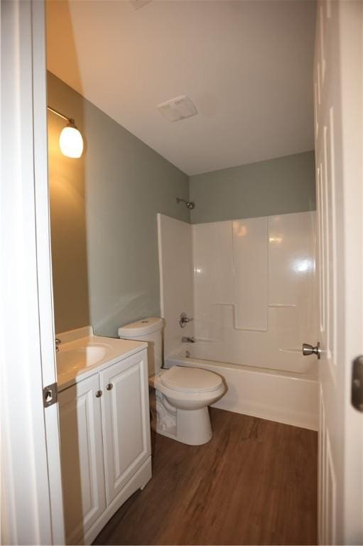 full bath with visible vents, toilet, shower / tub combination, wood finished floors, and vanity