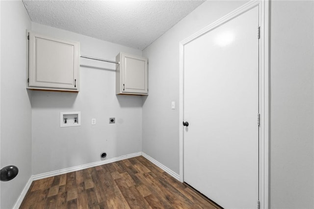 washroom featuring a textured ceiling, hookup for a washing machine, hookup for an electric dryer, dark wood-style flooring, and cabinet space