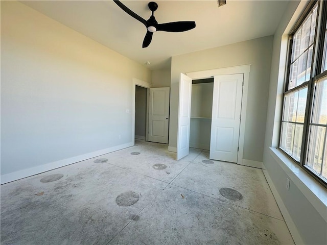 2550 Peterson Rd, Gentry, AR 72734 - unfurnished bedroom featuring a closet, baseboards, concrete floors, and ceiling fan