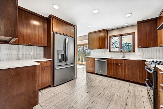 kitchen with open shelves, stainless steel appliances, light countertops, backsplash, and a sink