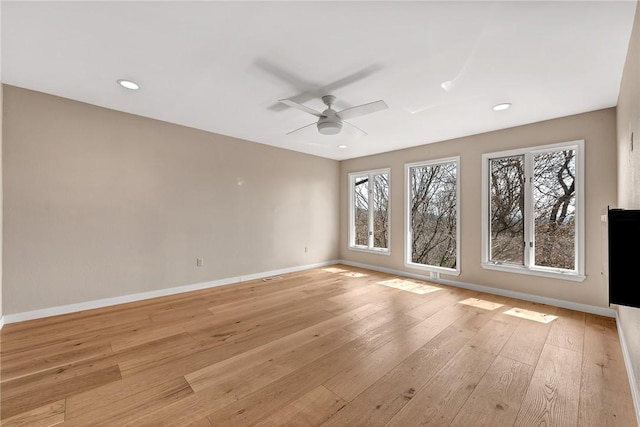 spare room featuring light wood-style floors, ceiling fan, baseboards, and recessed lighting