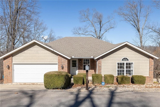 ranch-style home with a garage, concrete driveway, brick siding, and roof with shingles