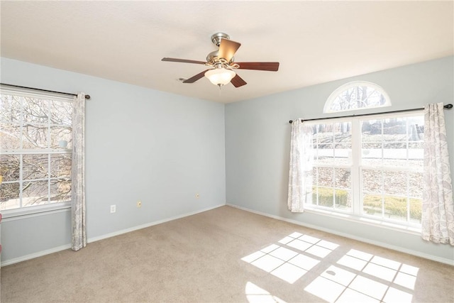 33 Rountree Dr, Bella Vista, AR 72715 - spare room featuring carpet flooring, plenty of natural light, a ceiling fan, and baseboards