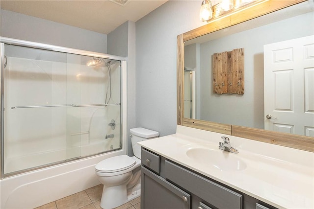 33 Rountree Dr, Bella Vista, AR 72715 - bathroom with vanity, toilet, tile patterned floors, and bath / shower combo with glass door