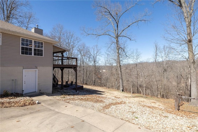 33 Rountree Dr, Bella Vista, AR 72715 - view of yard with a deck and a wooded view
