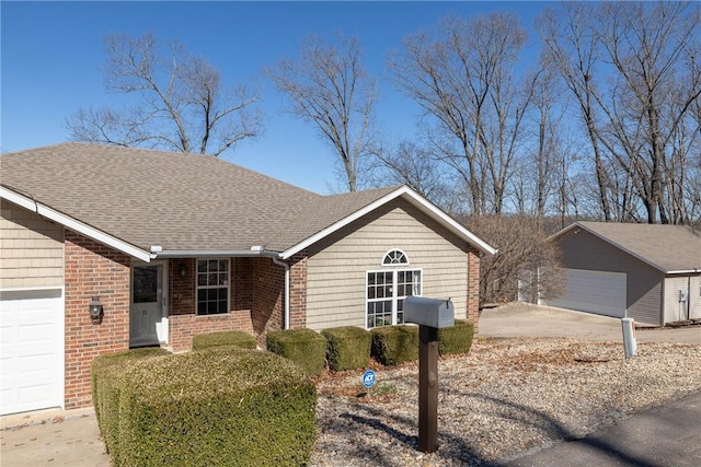 ranch-style house with brick siding, an outbuilding, and roof with shingles