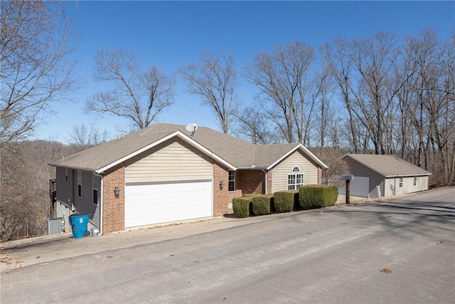 33 Rountree Dr, Bella Vista, AR 72715 - ranch-style house featuring brick siding, an attached garage, and central AC unit