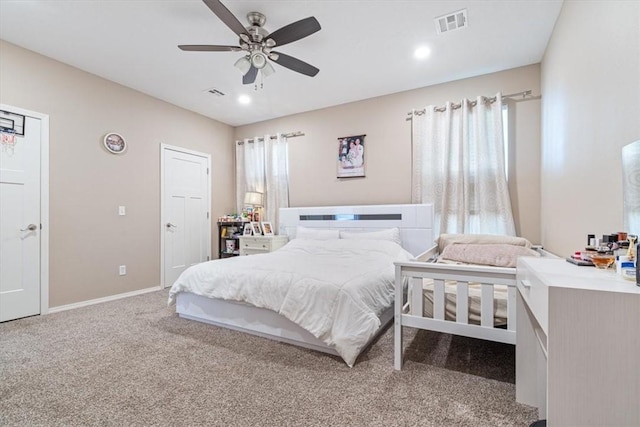 bedroom with a ceiling fan, baseboards, visible vents, and carpet flooring